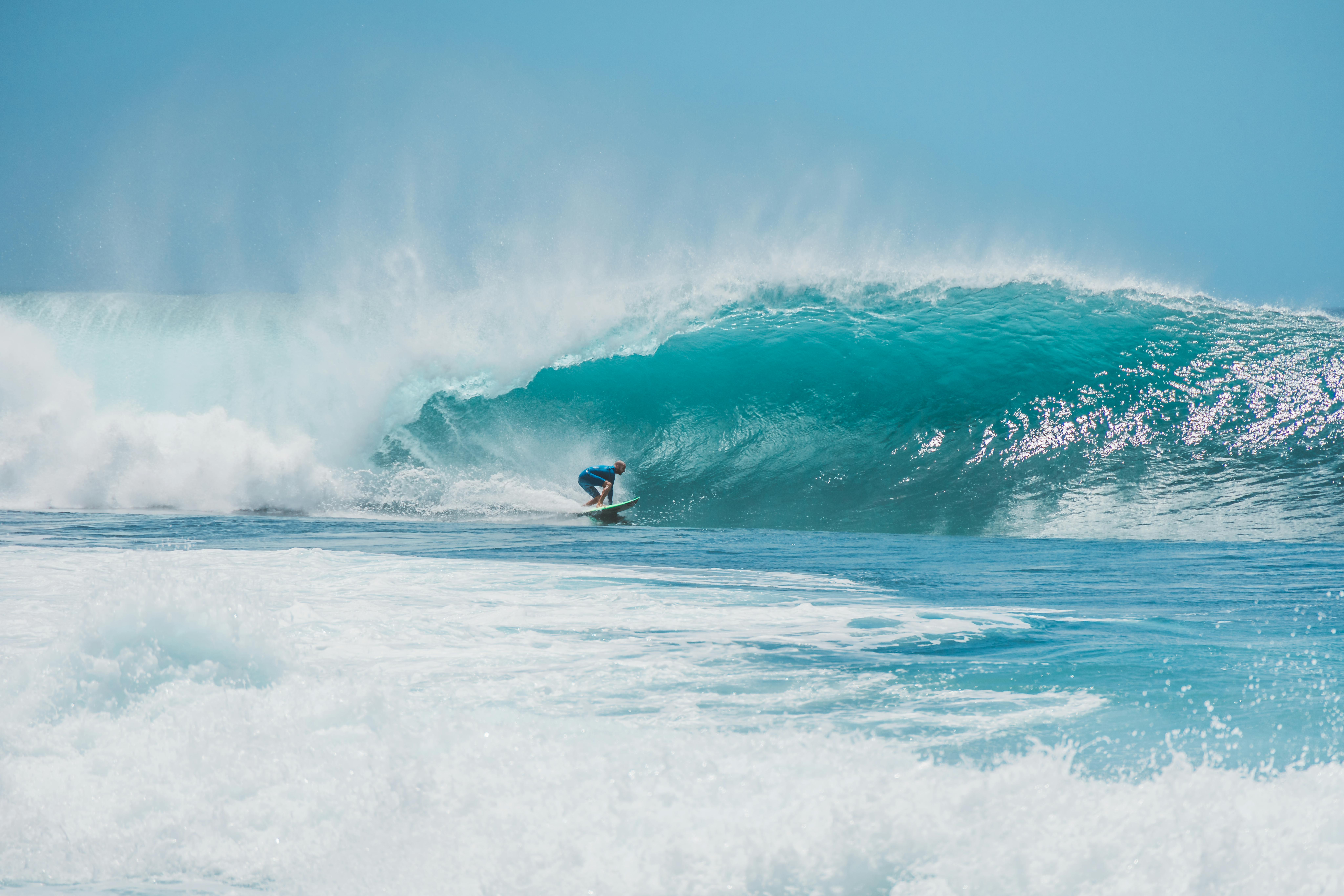 Surfer catching a wave at sunset